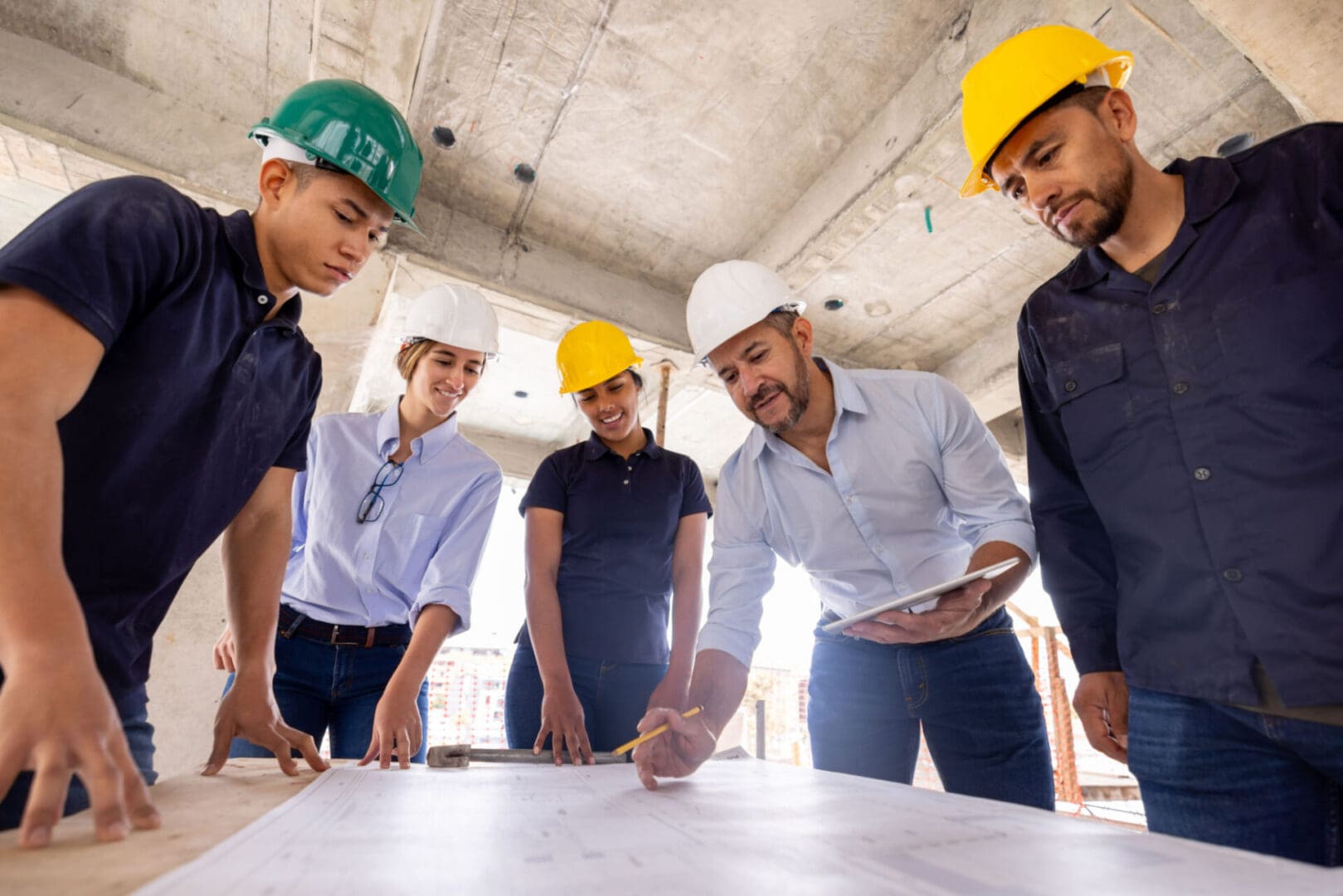 Construction team reviewing building plans together.